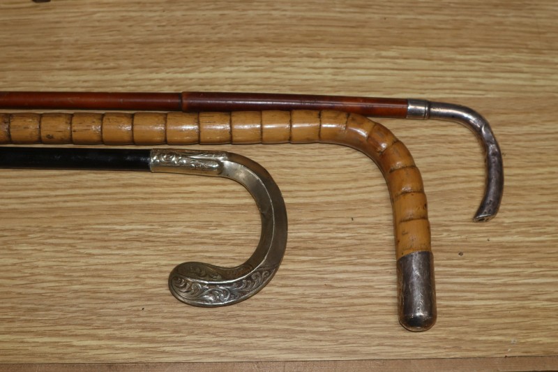 Two silver mounted walking cane and a parasol handle